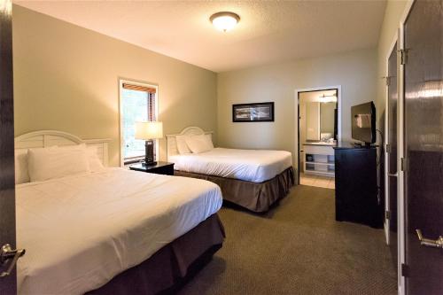 a hotel room with two beds and a mirror at Bay Colony Unit 771 - Upper Level in Nisswa