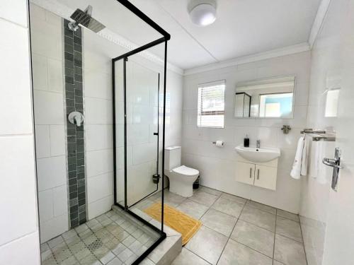 a bathroom with a shower and a toilet and a sink at The Legacy in East London