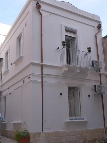 a white building with a balcony on the side at The Court Suites & Spa in Taranto