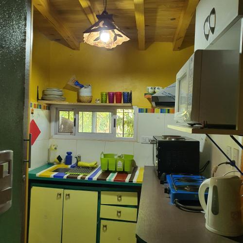 a kitchen with yellow cabinets and a counter top at Rancho Por Fin in Barreal