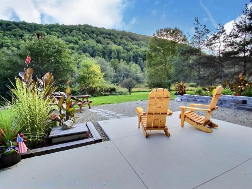 a patio with two chairs and a picnic table at The Maples w/ King Bed in Ellicottville