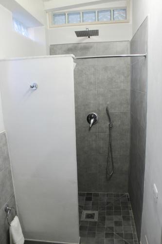a bathroom with a shower with a glass door at Cozy House in Tivoli