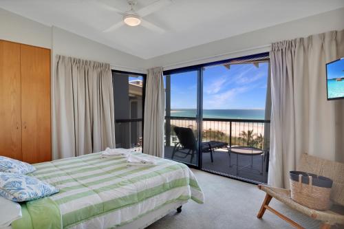 a bedroom with a bed and a view of the ocean at Cylinder Cove Unit 5 in Point Lookout