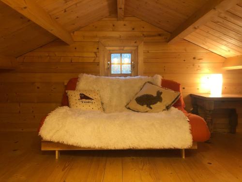 a couch with pillows on it in a cabin at The Chalet @ Giltar Grove Country House in Tenby