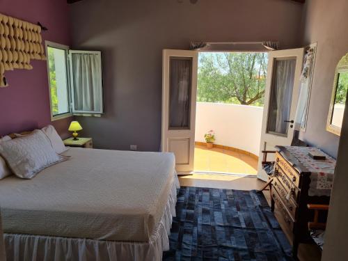 a bedroom with a bed and a large window at Santa Teresita in Cafayate