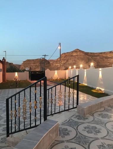 a black fence with a staircase in front of a building at منتجع مرايا in AlUla