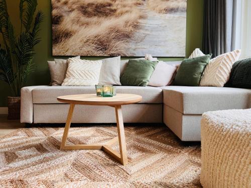 a living room with a couch and a coffee table at Abbey Green Lodge in Breda