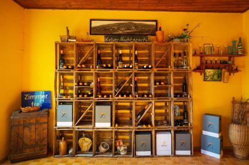 a shelf filled with lots of wine bottles at Der Weinladen in Kröv