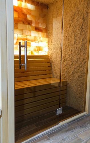 a walk in shower with a glass door at Drvena Kuca RUŽA in Kopaonik
