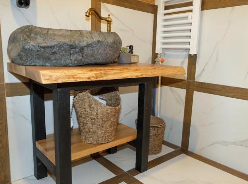 a console table with a rock on top at Drvena Kuca RUŽA in Kopaonik