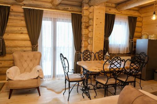 a dining room with a table and chairs at Drvena Kuca RUŽA in Kopaonik