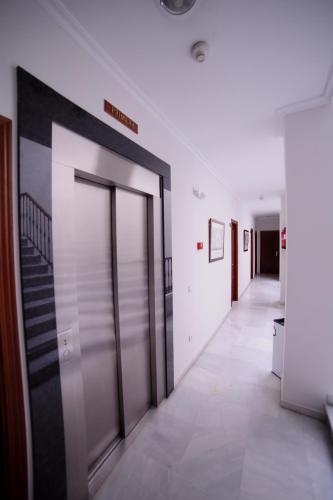 an office hallway with doors and a staircase at Hotel Doña Blanca in Seville