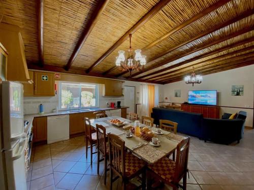 a kitchen and dining room with a table and chairs at Palma's Place Casanova Villa #WIFI#HEATEDPOOL#RELAX in Faro