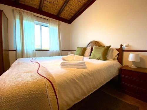 a bedroom with a large white bed with green pillows at Palma's Place Casanova Villa #WIFI#HEATEDPOOL#RELAX in Faro