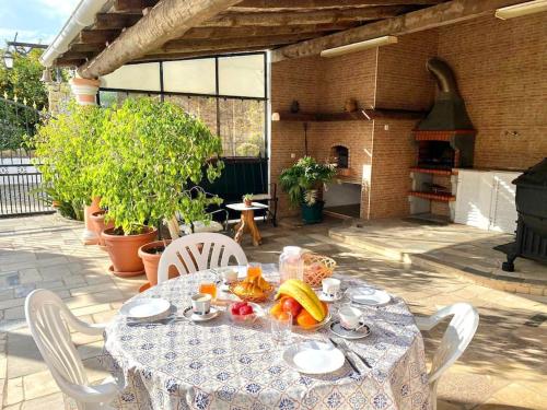 a table with a plate of fruit on a patio at Palma's Place Casanova Villa #WIFI#HEATEDPOOL#RELAX in Faro