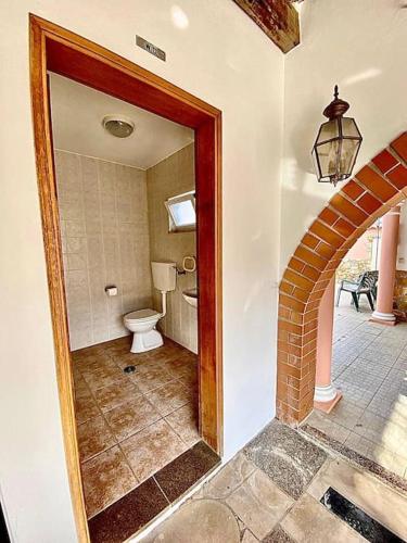 a bathroom with a toilet and a sink in a room at Palma's Place Casanova Villa #WIFI#HEATEDPOOL#RELAX in Faro