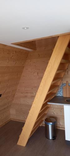 a wooden staircase in a room with wooden flooring at Demeure de la Garenne in Montmirail