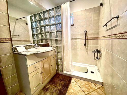 a bathroom with a sink and a shower at Palma's Place Casanova Villa #WIFI#HEATEDPOOL#RELAX in Faro