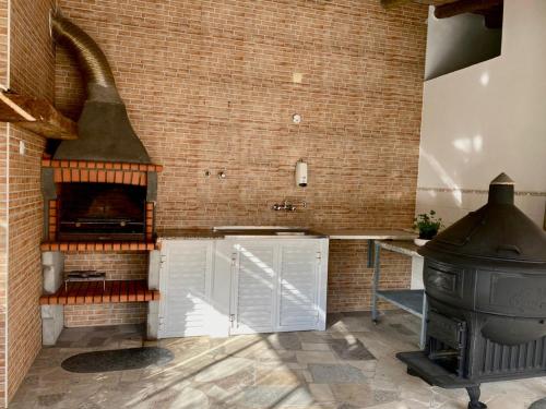 a kitchen with a stove and a brick wall at Palma's Place Casanova Villa #WIFI#HEATEDPOOL#RELAX in Faro
