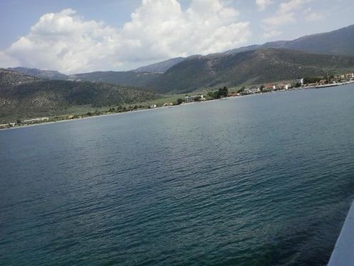 a large body of water with mountains in the background at Hotel Prinos in Prinos