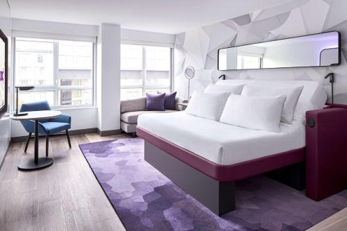A bed or beds in a room at YOTEL Washington DC