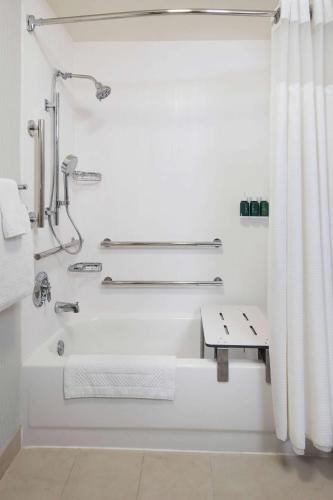 a bathroom with a shower and a bathtub with a shower curtain at Sonesta Select Atlanta Midtown Georgia Tech in Atlanta