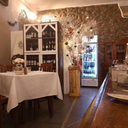 a dining room with a table and a refrigerator with wine bottles at Bellavista Hotel & Osteria in Lamporecchio