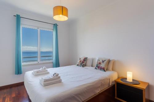 En eller flere senge i et værelse på Apartamento Estrela Azul