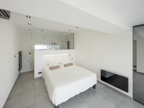 une chambre blanche avec un lit et une télévision dans l'établissement Villa 8 pers à 30m de la mer, à Sainte-Maxime