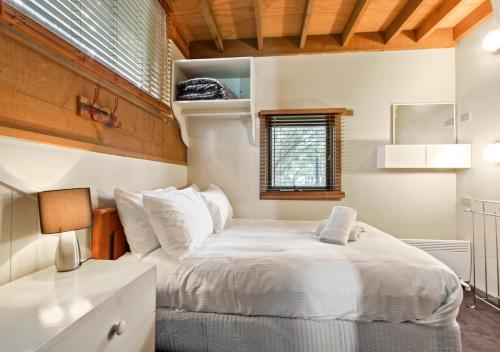a bedroom with a large white bed in a room at Bogong Jacks in Dinner Plain