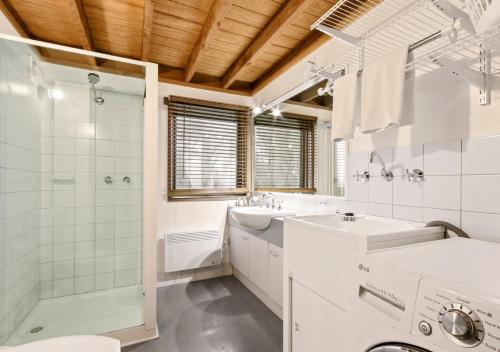a bathroom with a sink and a shower and a toilet at Bogong Jacks in Dinner Plain