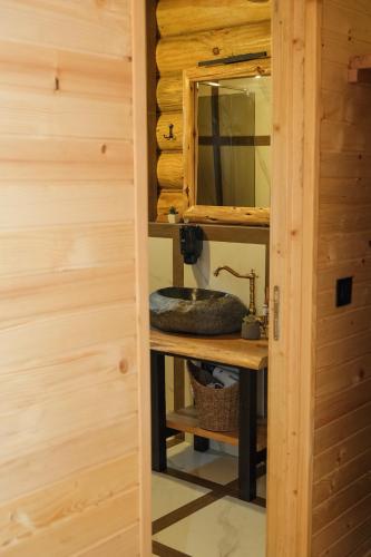 a bathroom with a sink and a mirror at Drvena Kuca RUŽA in Kopaonik