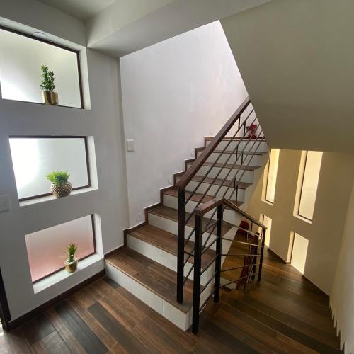 a staircase in a house with wooden floors at Casa boutique ROMA in Mineral del Monte