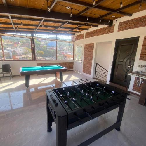 a ping pong table in a room with a pool table at Casa boutique ROMA in Mineral del Monte