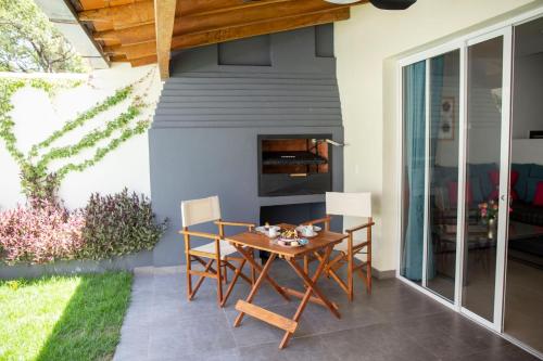 a patio with a table and chairs and a fireplace at Hotel Oasis-Dream Holidays - La Petite France in San Bernardino