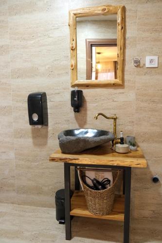 a bathroom with a sink and a mirror at Drvena Kuca RUŽA in Kopaonik