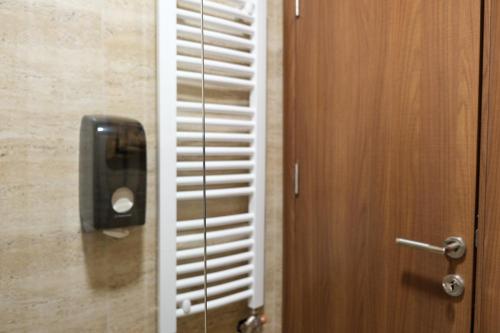a wooden door with a paper towel dispenser on it at Drvena Kuca RUŽA in Kopaonik