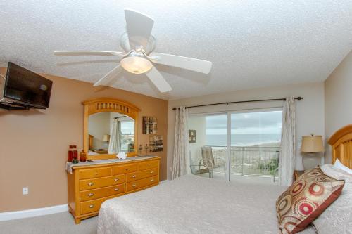 a bedroom with a bed and a ceiling fan at 414 Madeira Norte Condo in St. Pete Beach