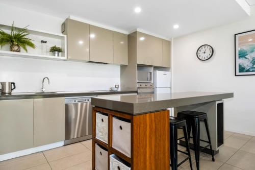 an open kitchen with a counter and a sink at Pullman Magenta Shores Resort in The Entrance