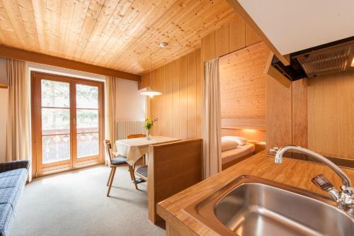 a kitchen with a sink and a desk in a room at Residence Pichlerhof in Rasun di Sopra