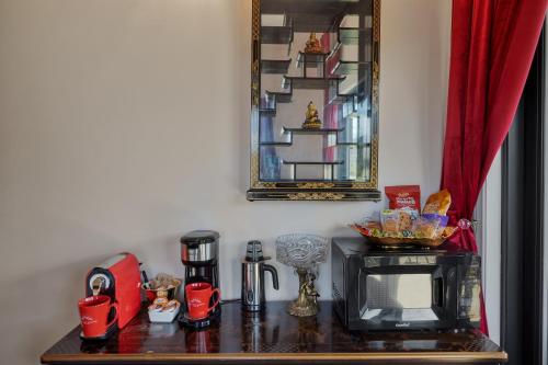 a table with a television and a microwave on it at Quiet Mind Mountain Lodge, Retreat & Spa in Julian