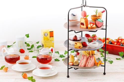 a three tiered display of pastries and cups of tea at Shin Osaka Esaka Tokyu REI Hotel in Suita
