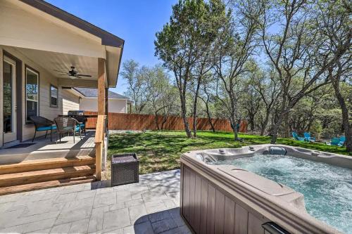 a backyard with a hot tub on a patio at Convenient Cute Cottage Hot Tub Fire Pit Sleeps 6 in Canyon Lake