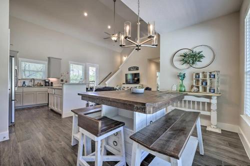 a kitchen with a large wooden table and benches at Convenient Cute Cottage Hot Tub Fire Pit Sleeps 6 in Canyon Lake