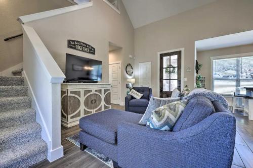 a living room with two blue chairs and a tv at Convenient Cute Cottage Hot Tub Fire Pit Sleeps 6 in Canyon Lake
