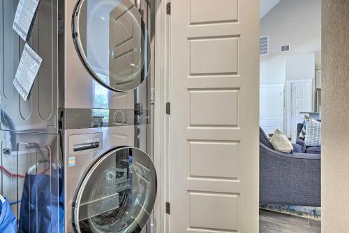 a kitchen with a washer and dryer next to a door at Convenient Cute Cottage Hot Tub Fire Pit Sleeps 6 in Canyon Lake