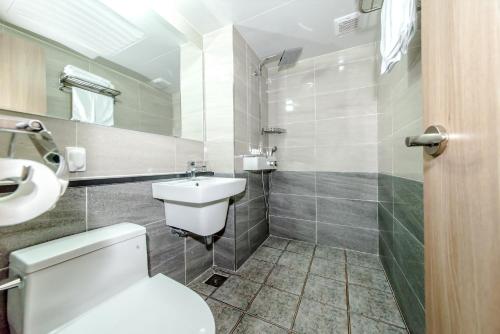 a bathroom with a white toilet and a sink at Index Hotel J Dream Jeju in Jeju