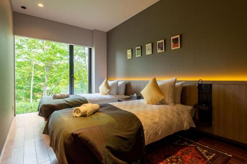מיטה או מיטות בחדר ב-Setsuin Niseko Hanazono