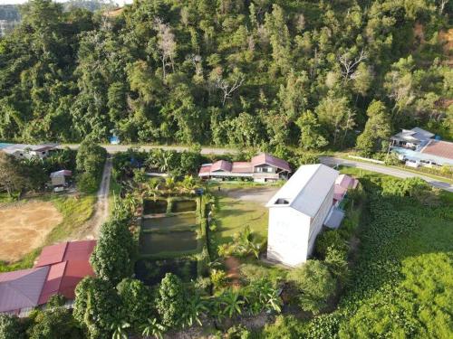 an aerial view of a house with a yard at Noungan Farm Homestay in Penampang