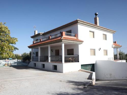 a white building with a balcony on top of it at Private villa en baza in Baza